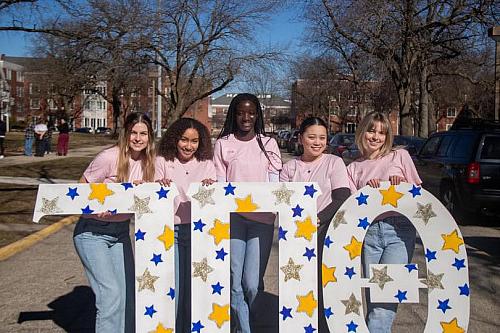 Candis Damste posing for a picture with friends.